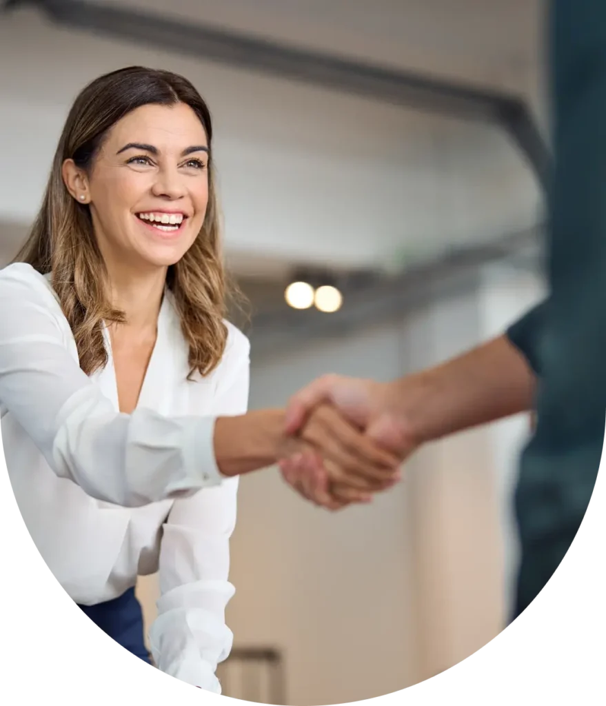 woman shaking hands with person out of frame